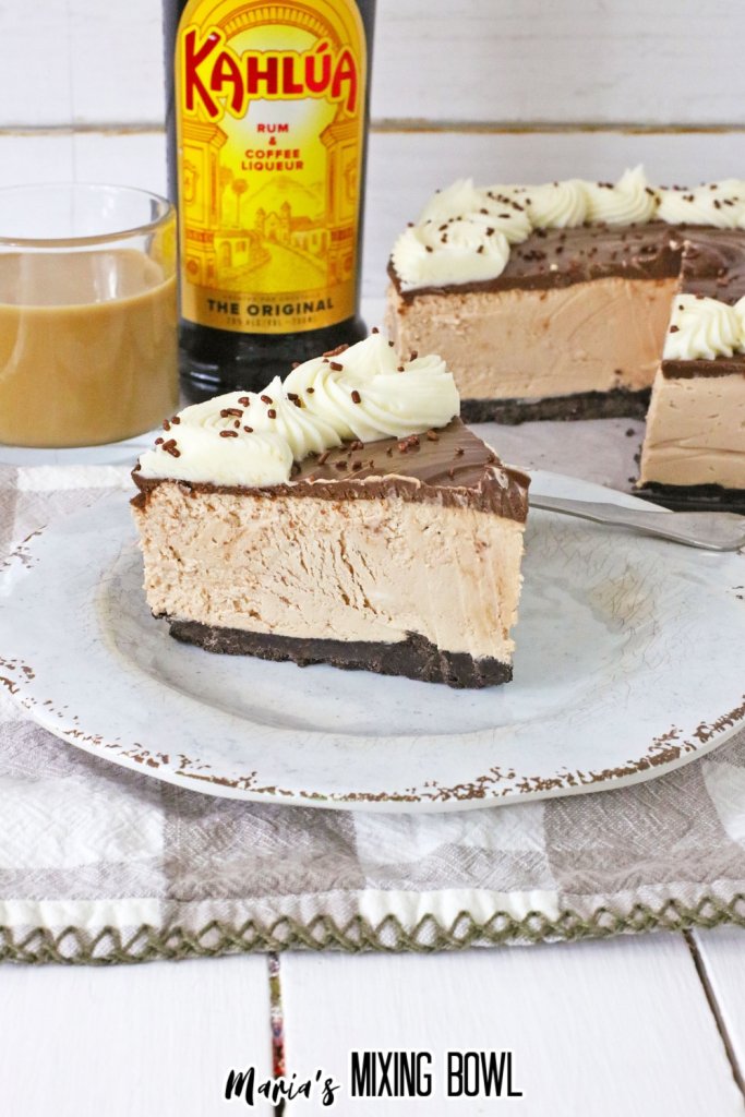 slice of no bake kahlua cheesecake on a white plate with gold rim