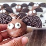 oreo bat truffle held in a womans fingers