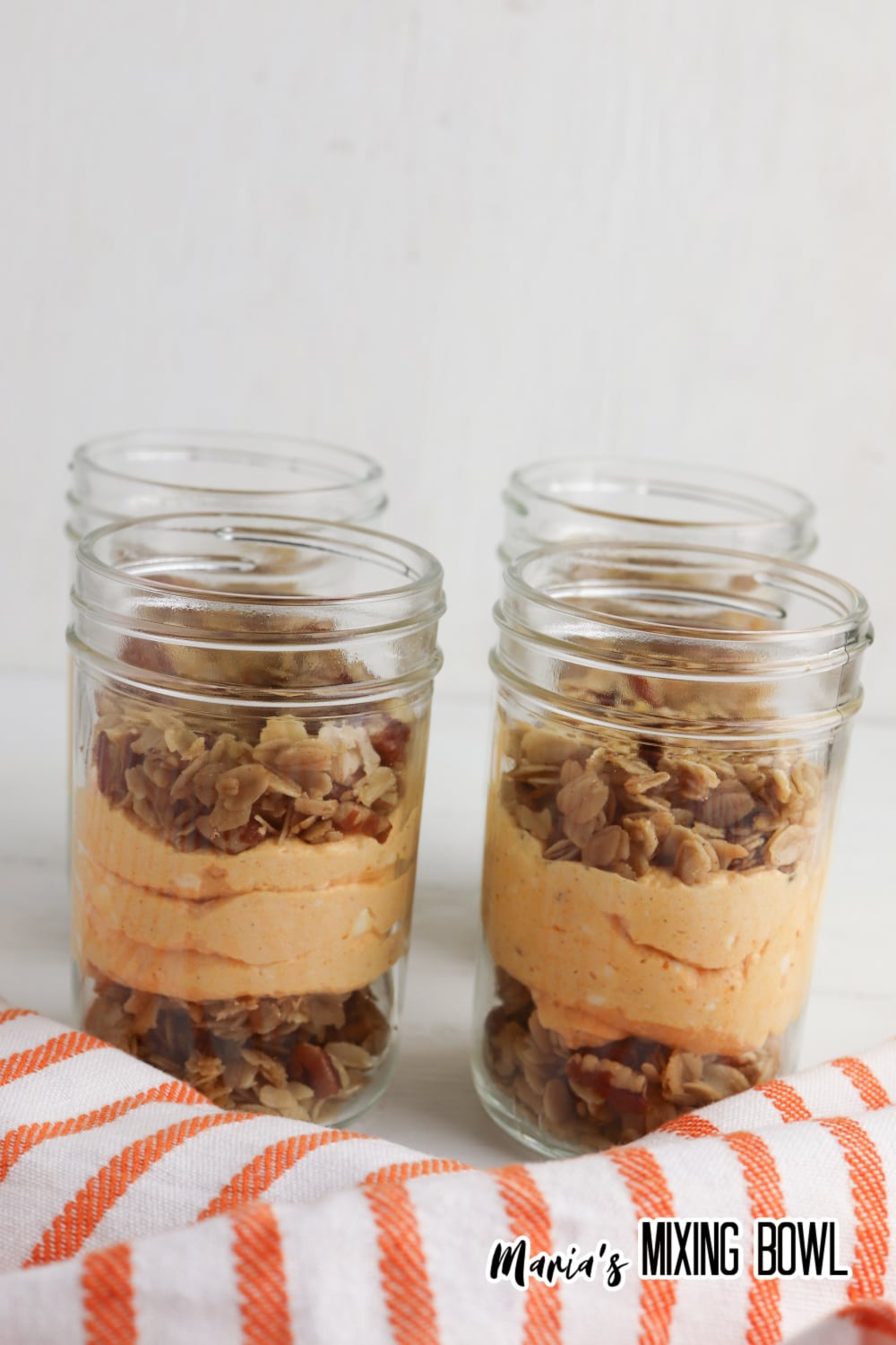 parfaits being layered in glass mason jars