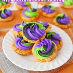 pumpkin sugar cookies with butter cream frosting on a white plate with the name in text