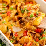 taco pasta shells in a white casserole dish with the name in text