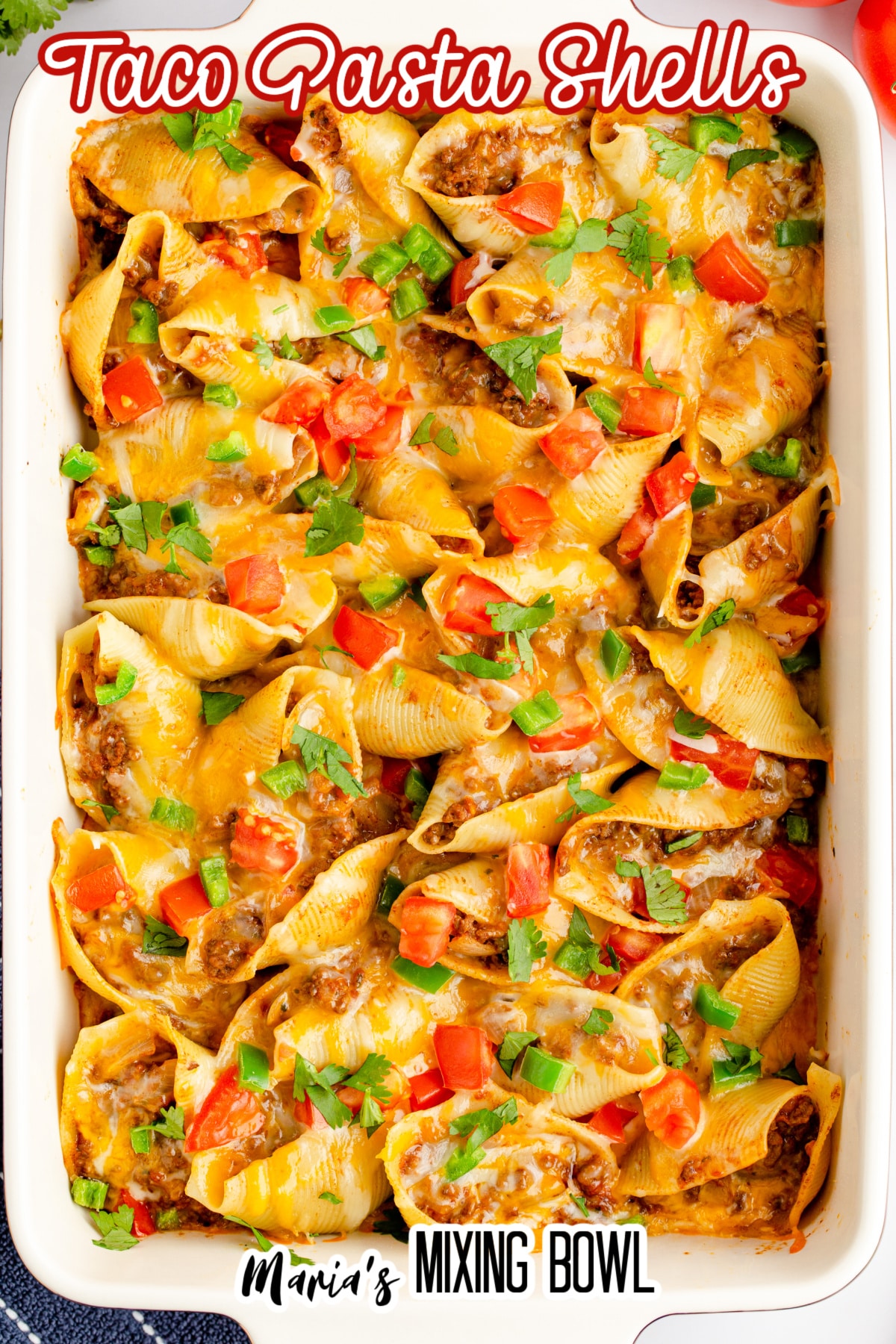 casesrole dish full of taco pasta shells in a white casserole dish with the name in text
