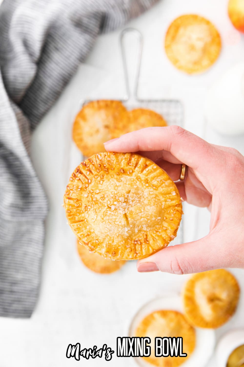air fryer apple hand pie held in the womens fingers