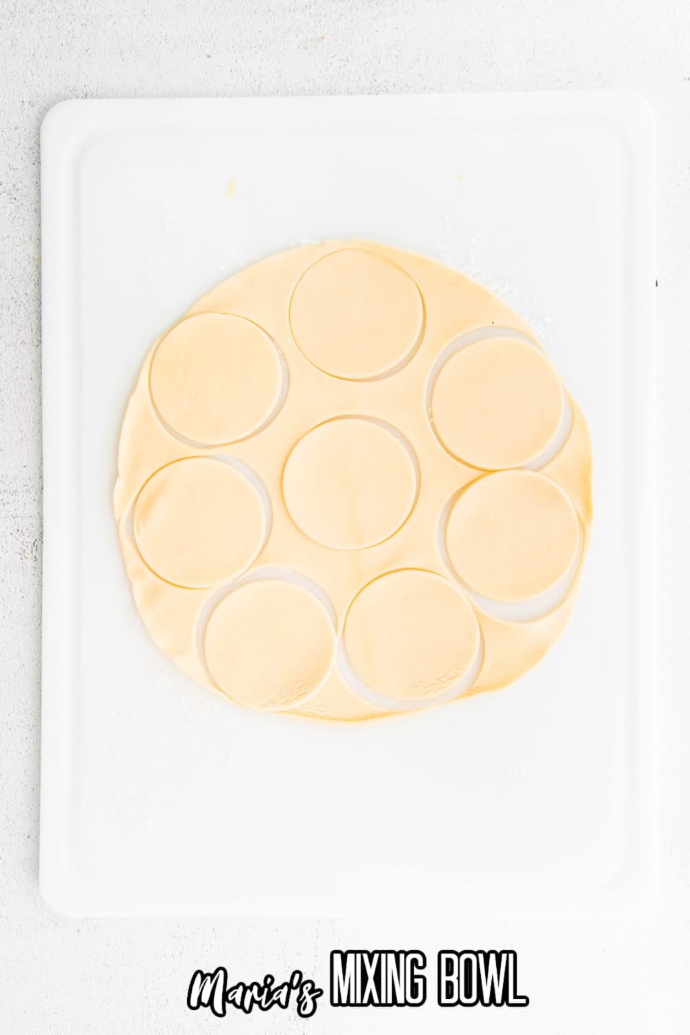 pie crust cut into circles on a parchment lined baking sheet