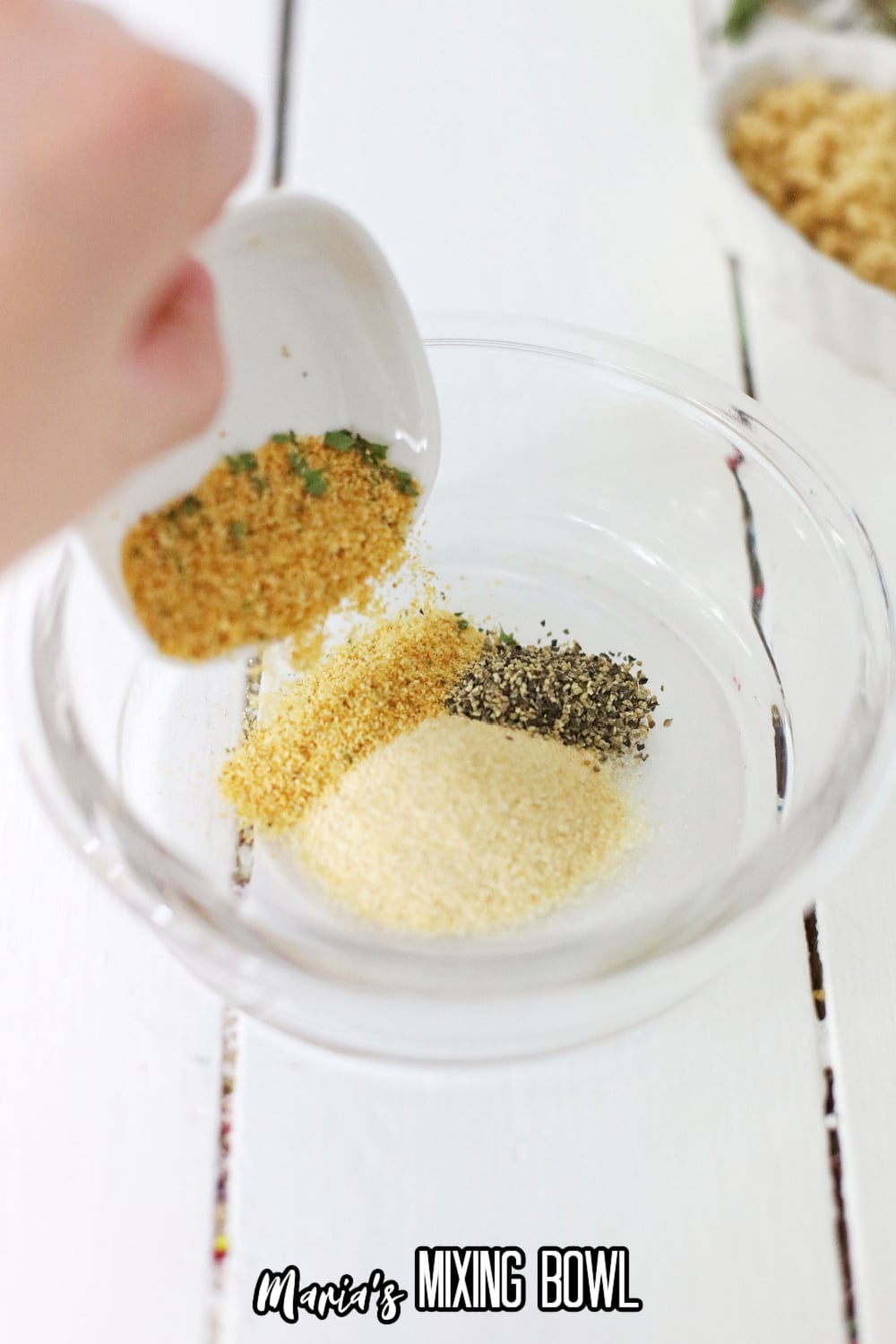 seasonings being mixed in a white bowl