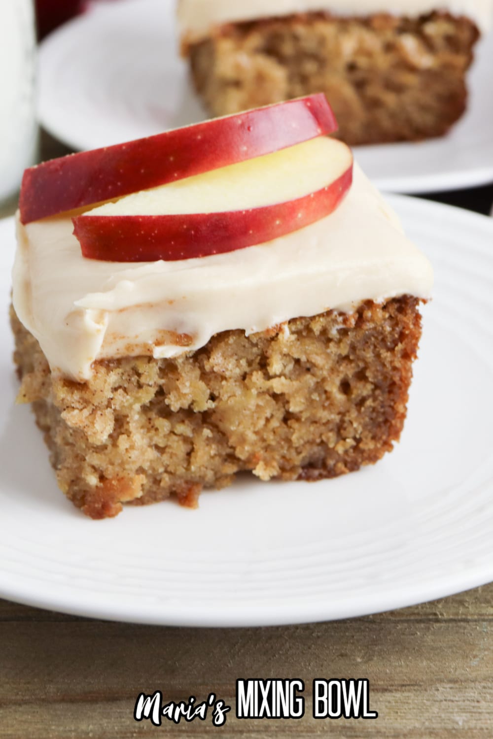 slice of apple cake with caramel icing on a white plate
