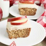 slice of apple cake with caramel icing on a white plate