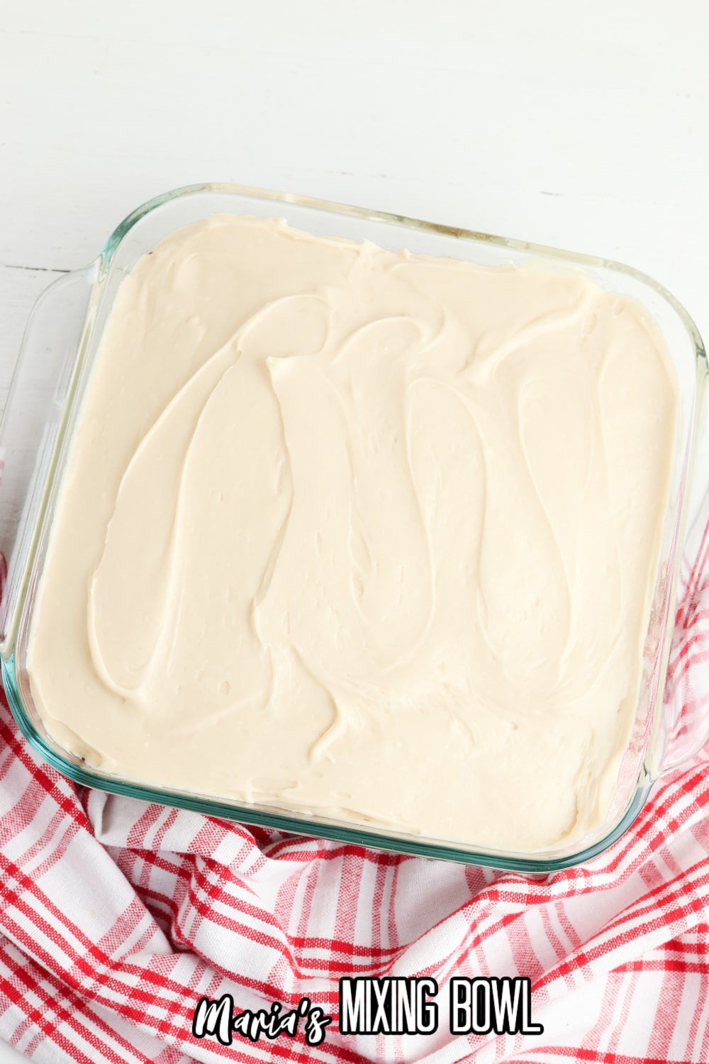 frosted dessert in a square glass baking pan