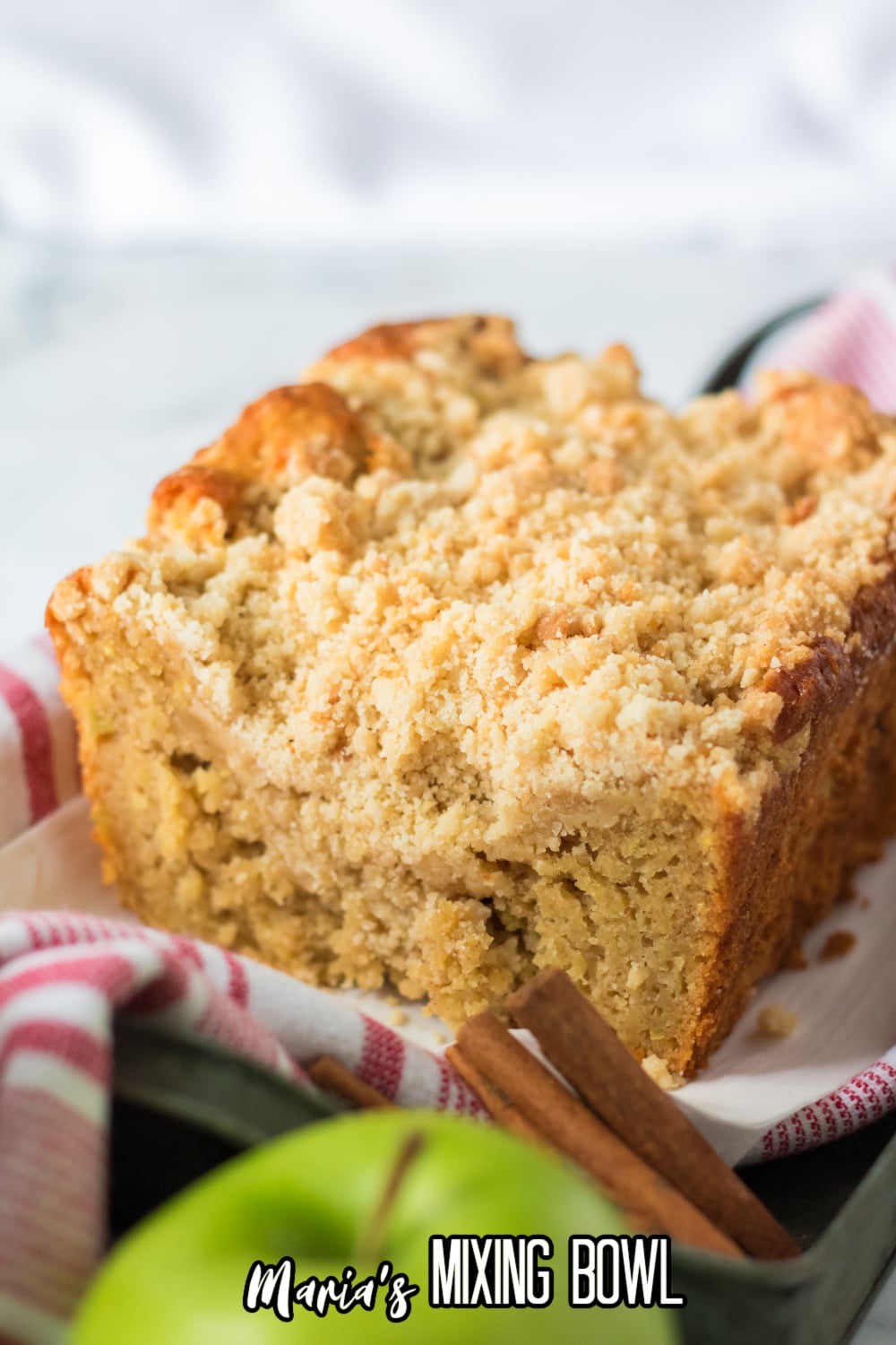 whole apple streusel cake on a red and white napkin