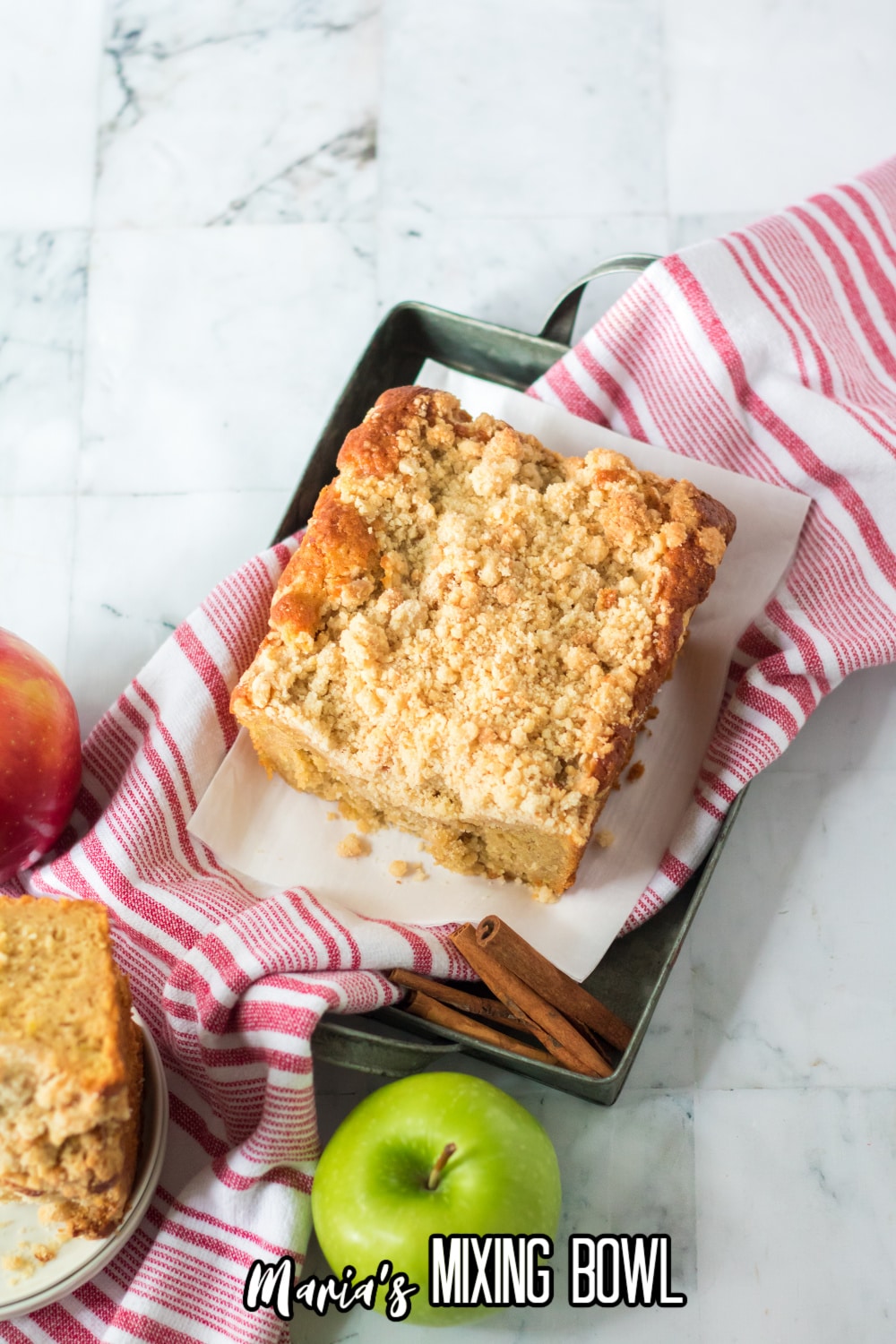 whole apple streusel cake on a red and white napkin