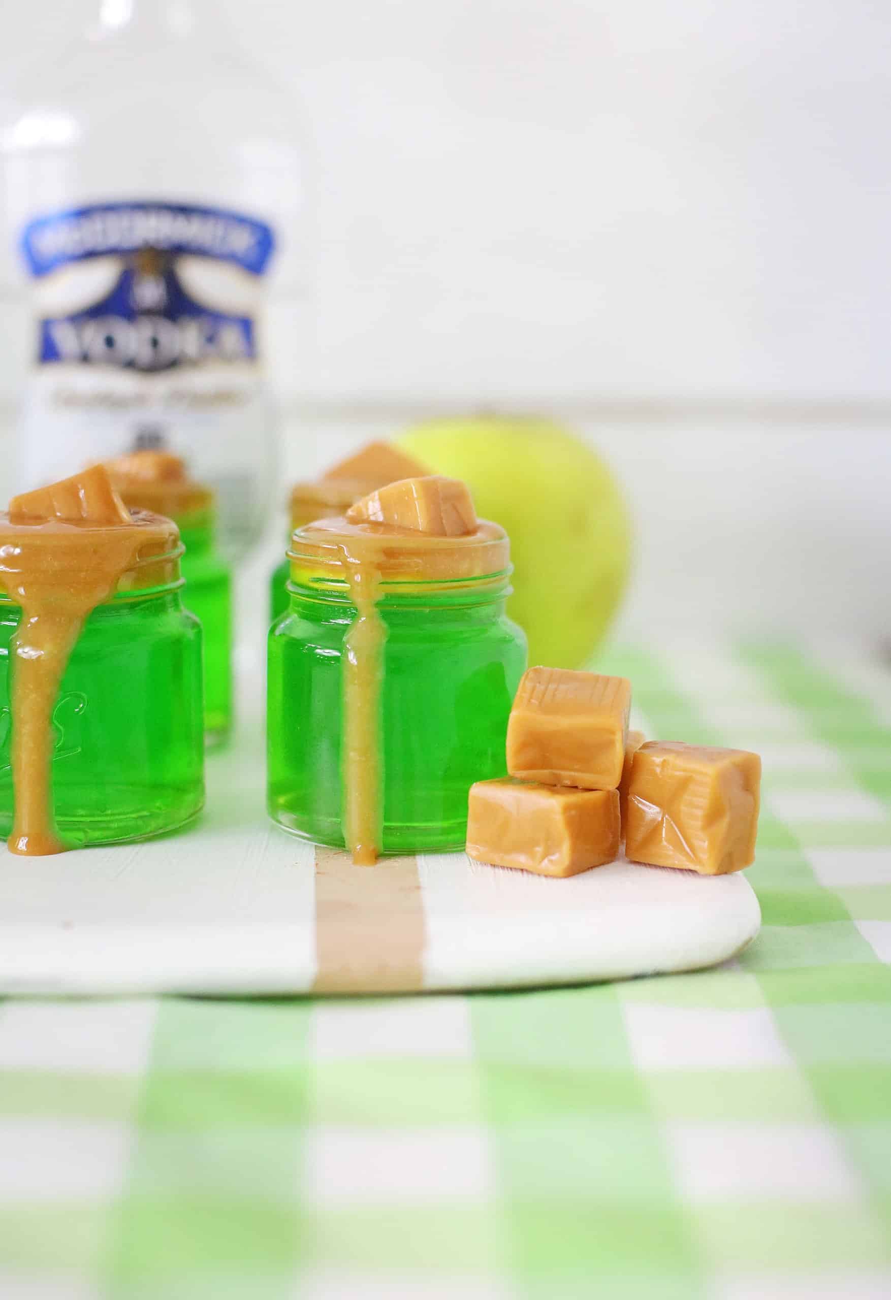 four caramel apple jello shots on a white towel