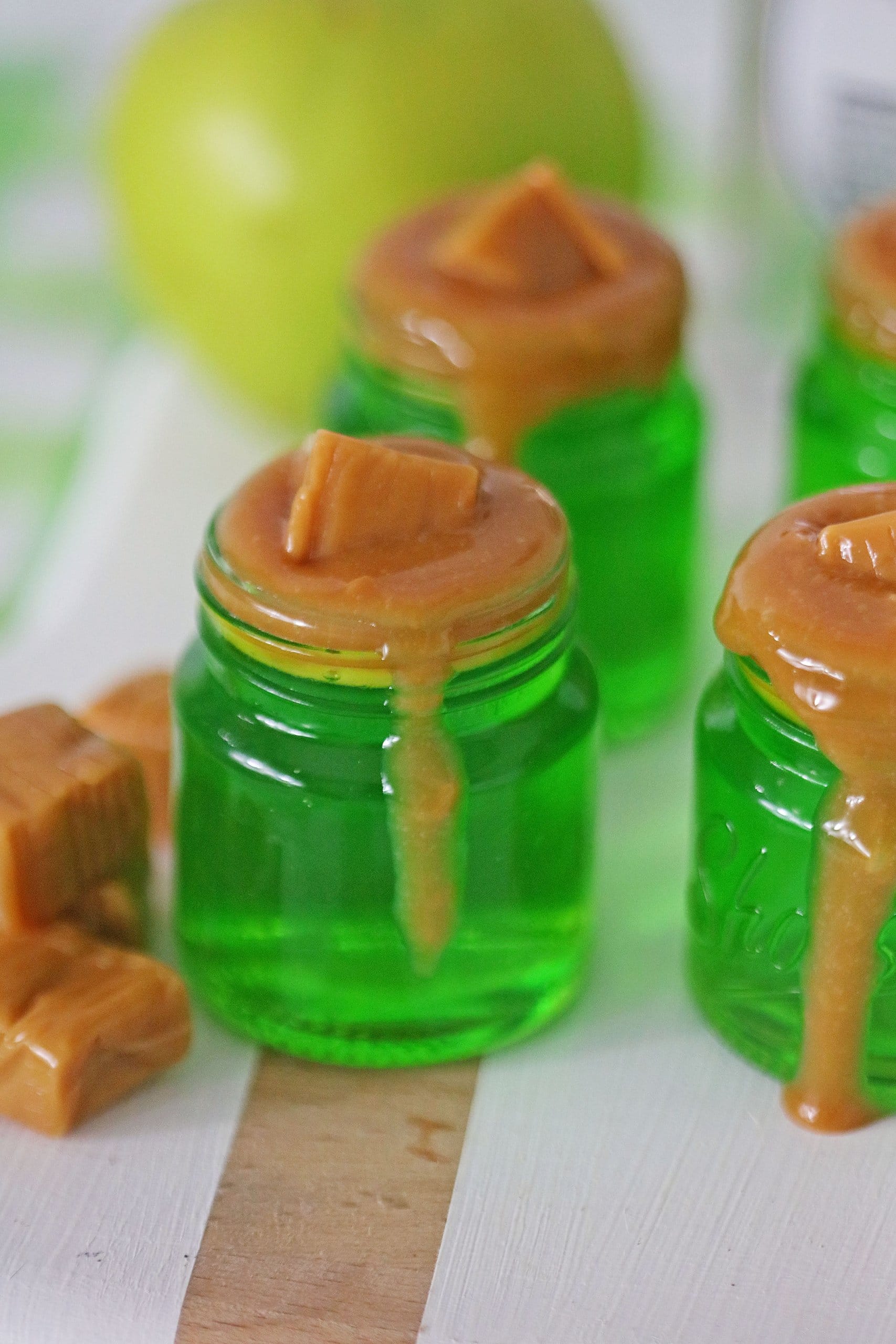 four caramel apple jello shots on a white towel