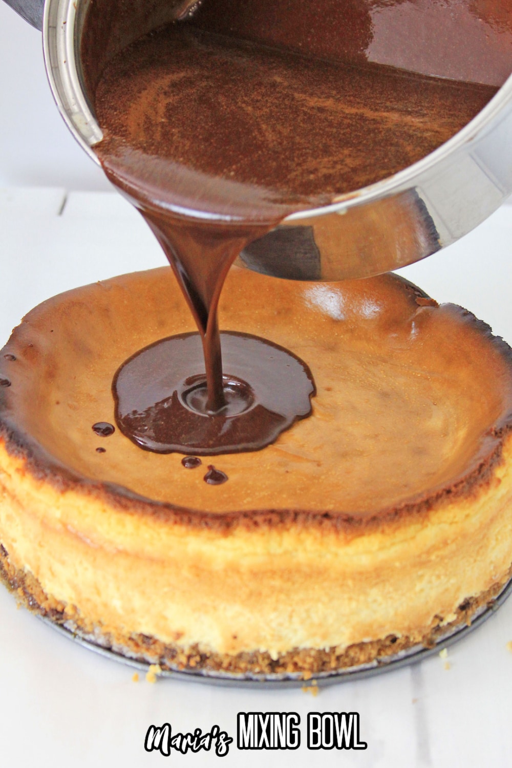 chocolate ganache being poured over a dsesert