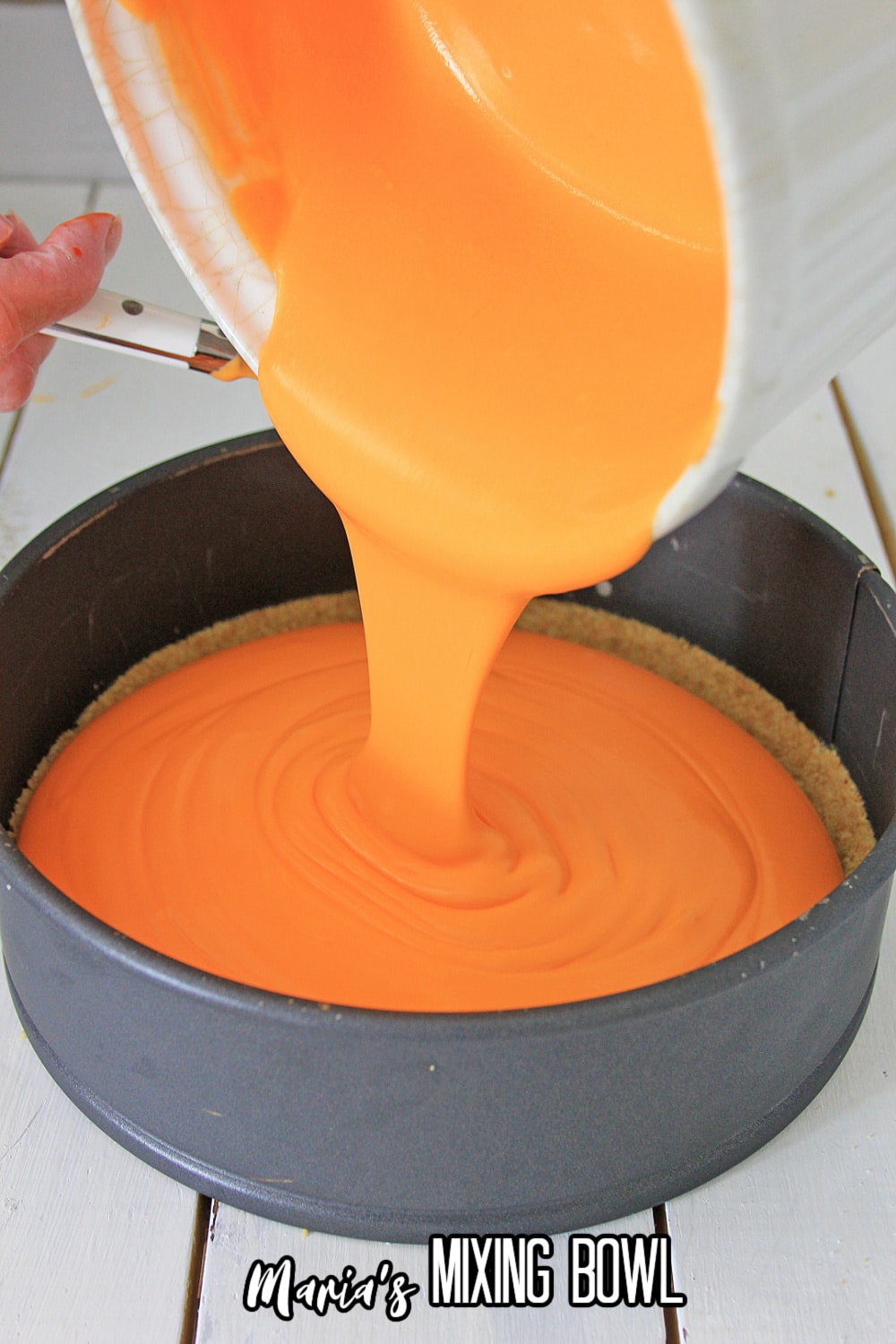 batter being poured into a springform pan