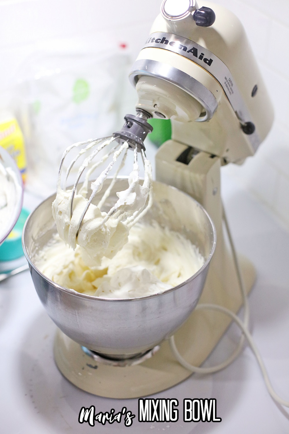 cheesecake and sugar in a stand mixing bowl