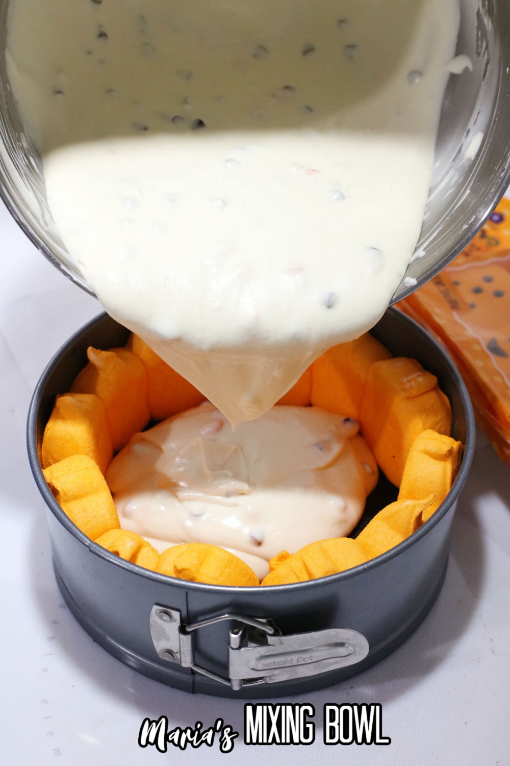 batter being poured into a springform pan
