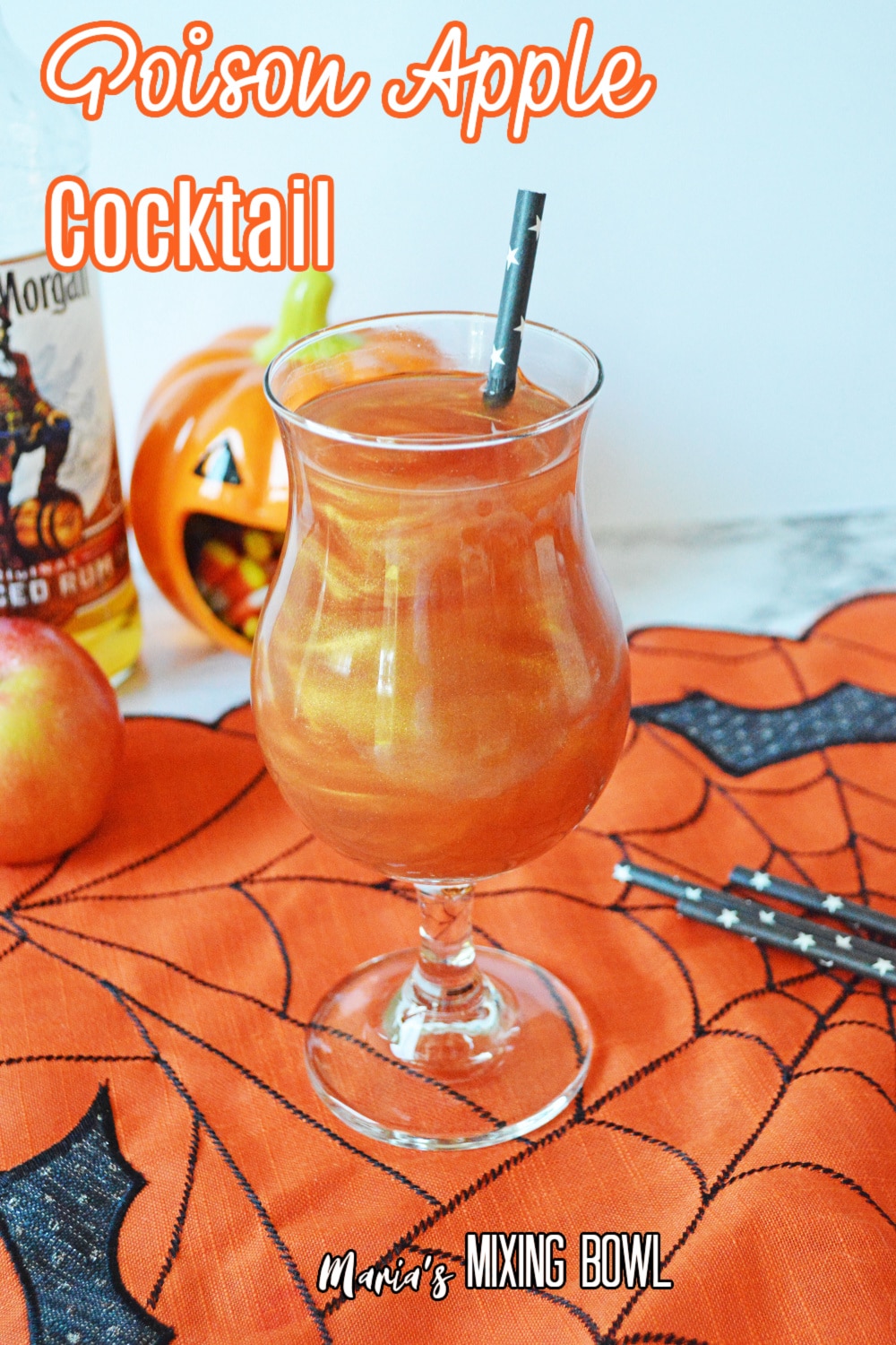 glass of poison apple cocktail on a siderweb towel