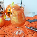 glass of poison apple cocktail on a siderweb towel