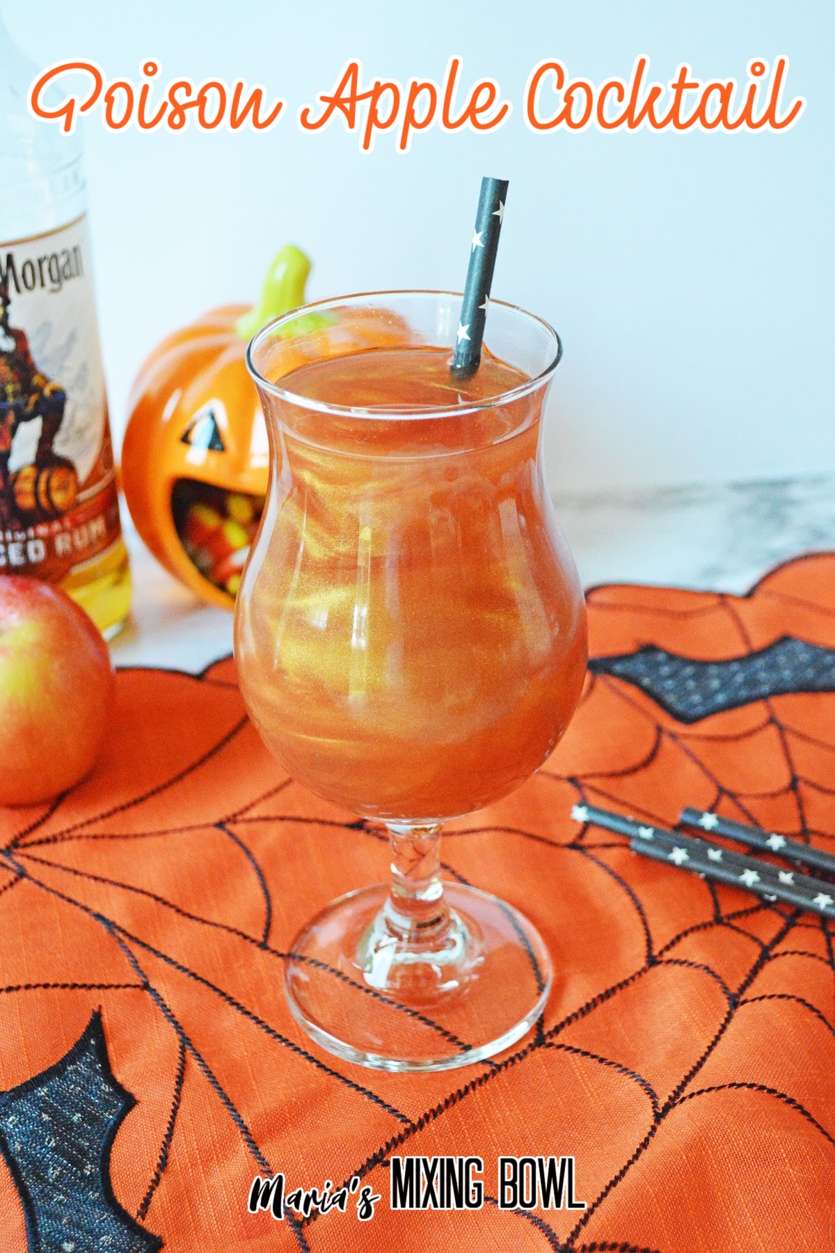 glass of poison apple cocktail on a siderweb towel