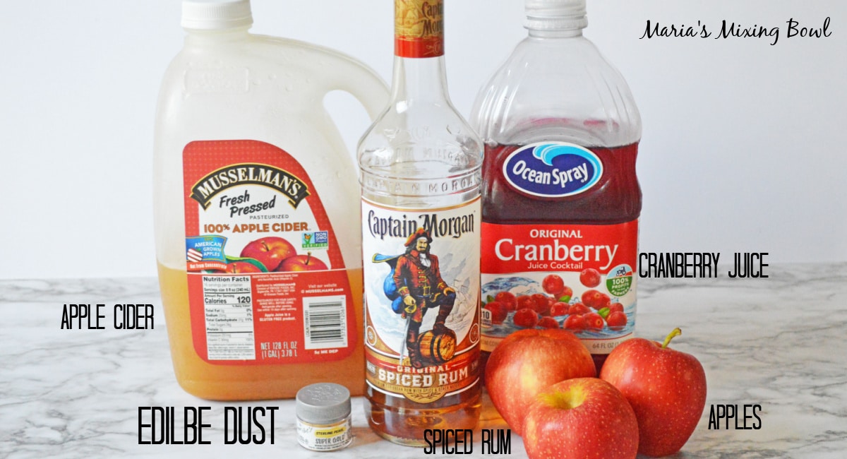 apple cider, spiced rum, cranberry juice, apples, and edible luster dust labelled with text