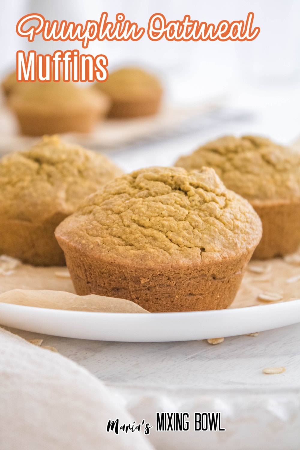 three pumpkin oatmeal muffins on a white plate