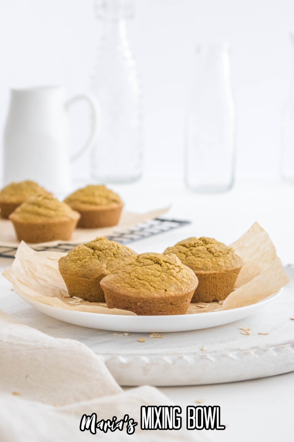 three pumpkin oatmeal muffins on a white plate