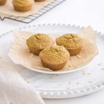three pumpkin oat muffins on a white plate