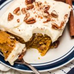 slice of pumpkin pecan bars on a white and blue plate