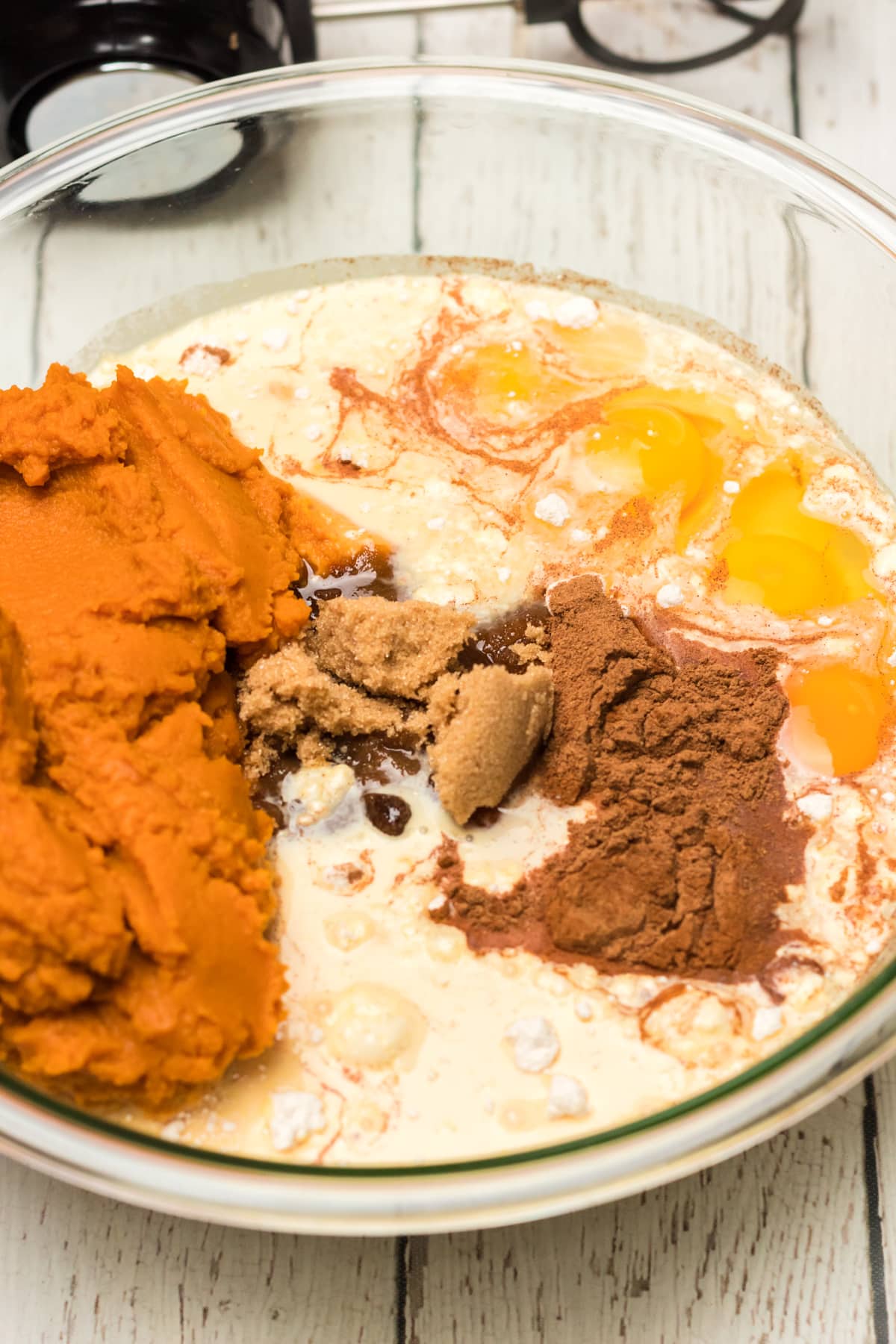 flour, eggs, brown sugar and spices in a glass mixing bowl