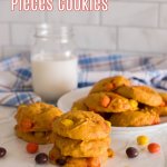 stacked pumpkin reese's pieces cookies on a marble counter