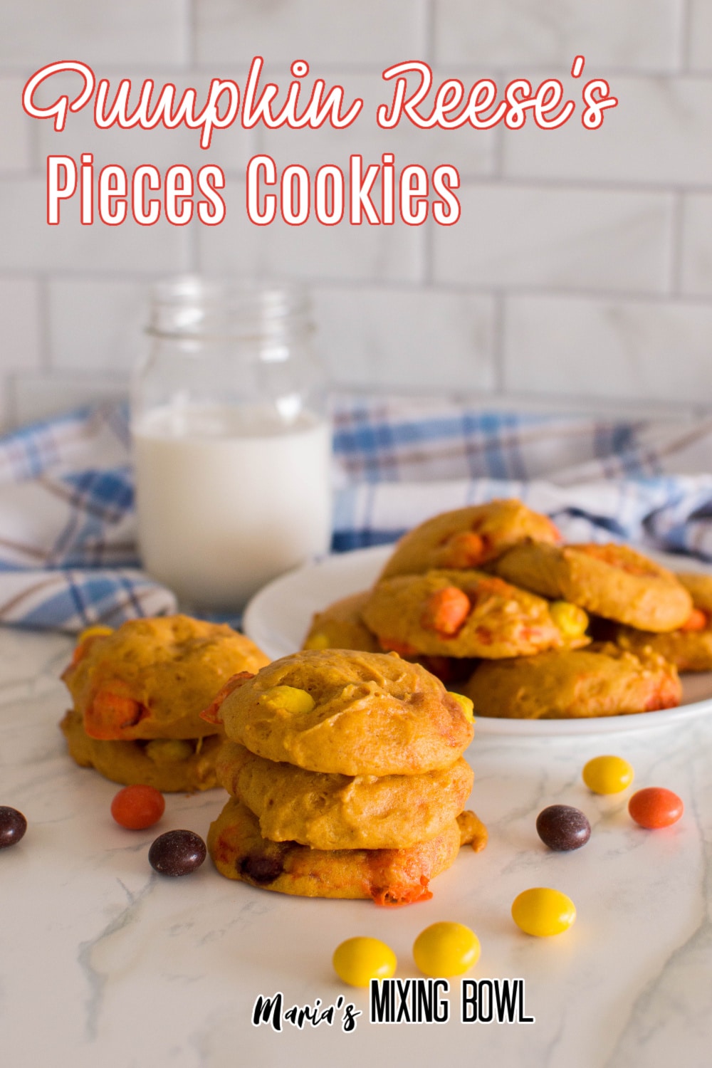 stacked pumpkin reese's pieces cookies on a marble counter