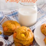 pumpkin reese's pieces cookies on a blue, white and gray kitchen towel