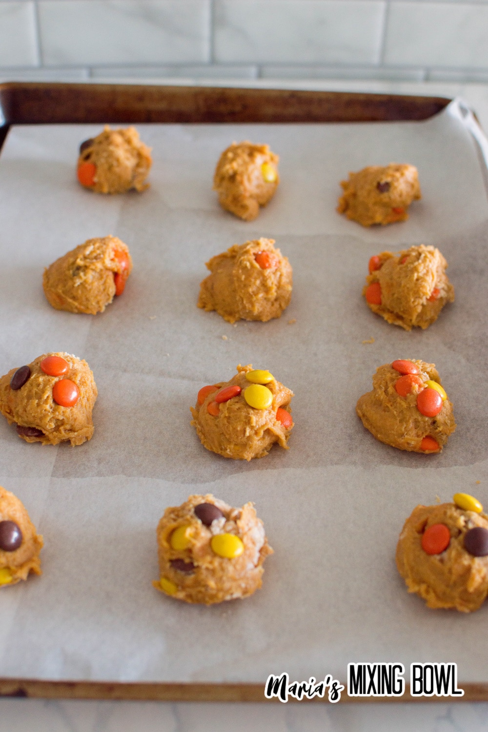 dough balls on a parchment lined baking sheet