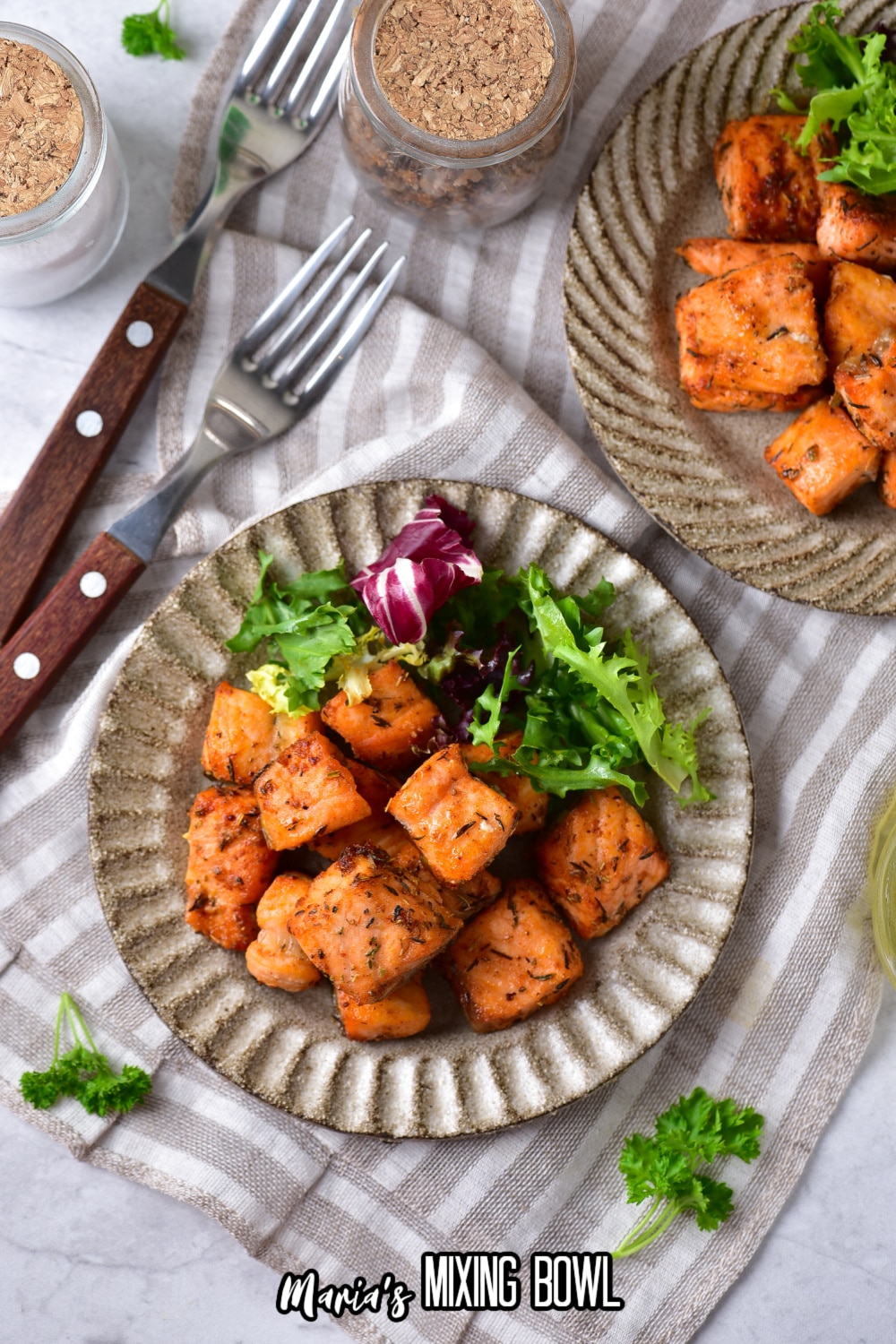 air fryer salmon bites on a plate with salad as a side