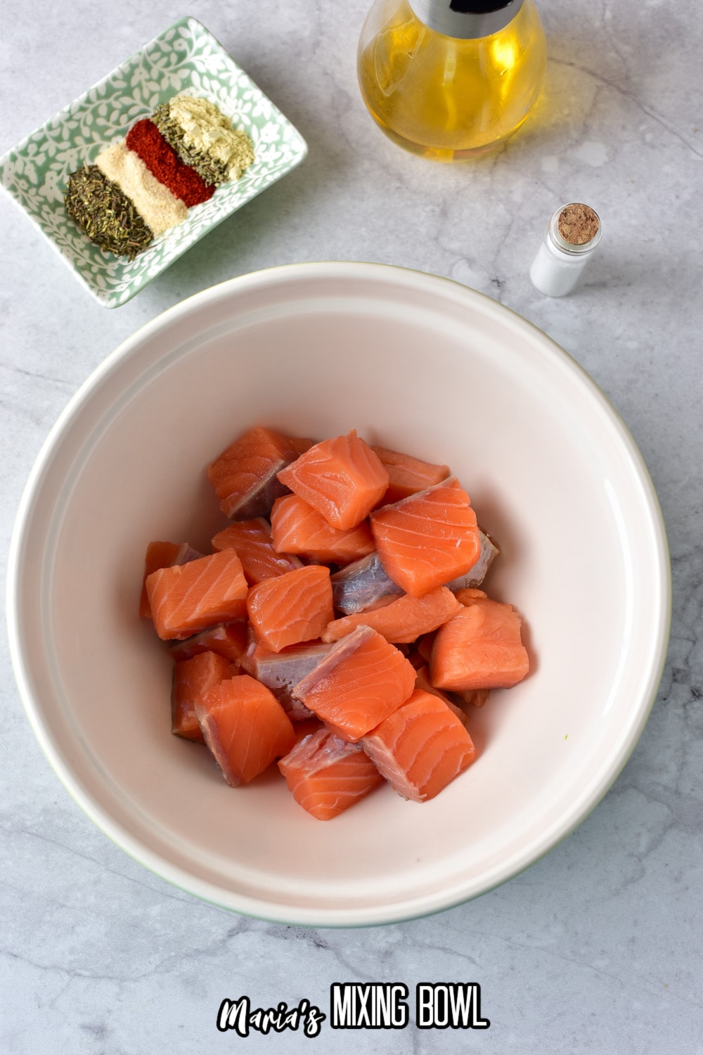 chucks of fish in a white mixing bowl