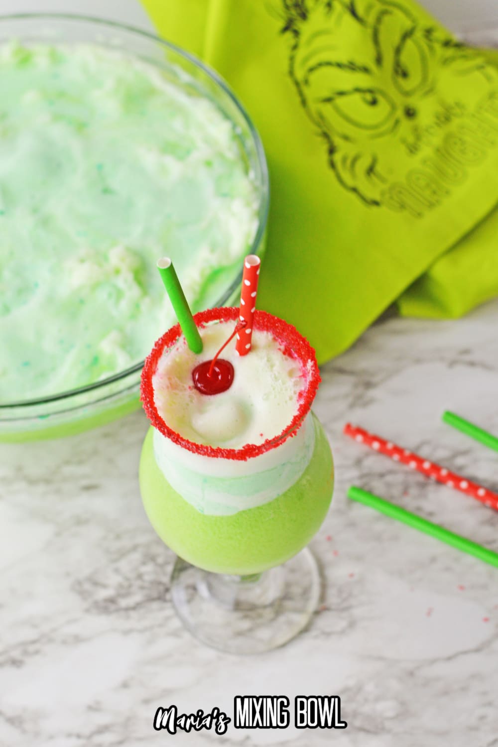 boozy grinch punch topped with a cherry