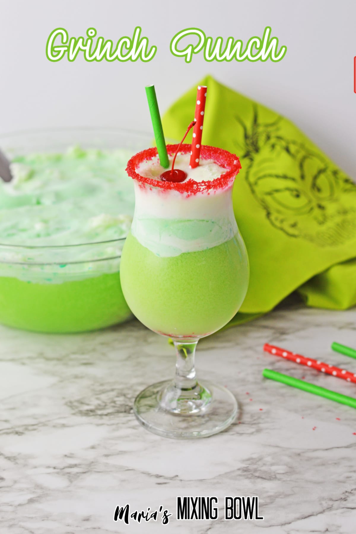 boozy grinch punch with a cherry on it with the name in text for pinterst