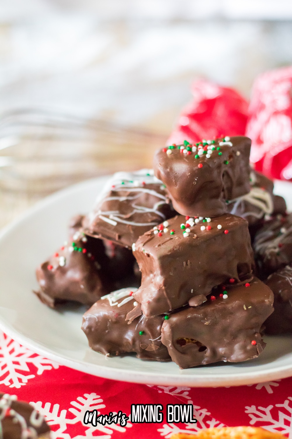 chocolate covered honeycomb brittle stacked on a white plate