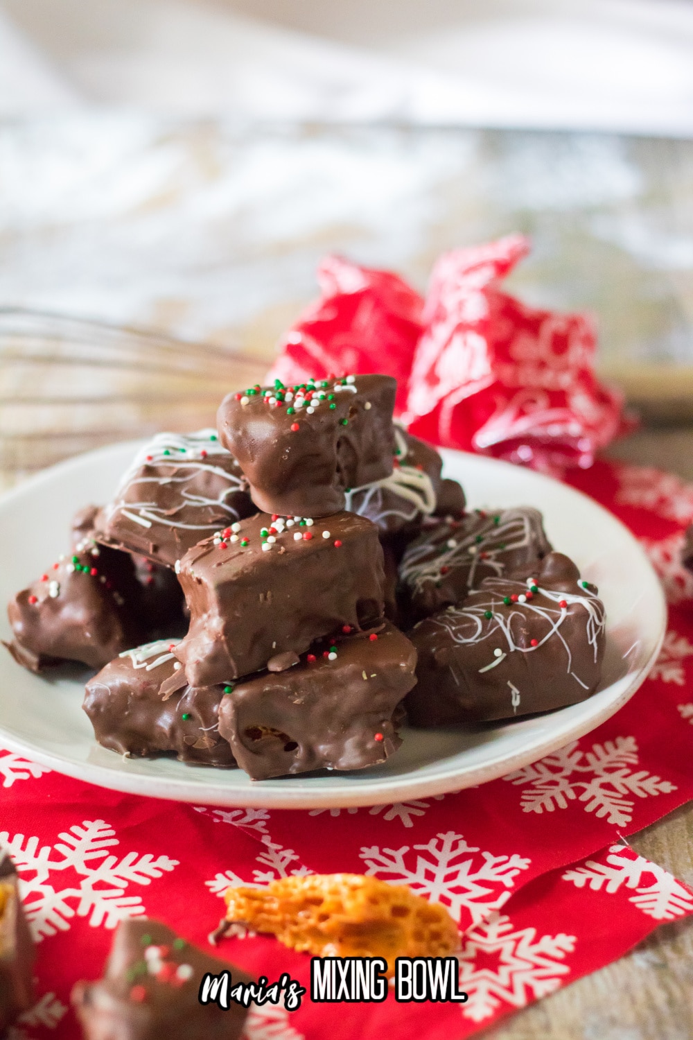 chocolate covered honeycomb brittle stacked on a white plate