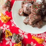 chocolate covered honeycomb brittle stacked on a white plate