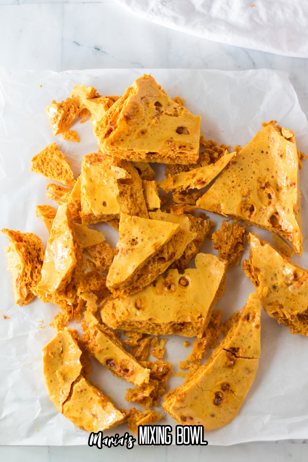 broken pieces of brittle on a parchment paper
