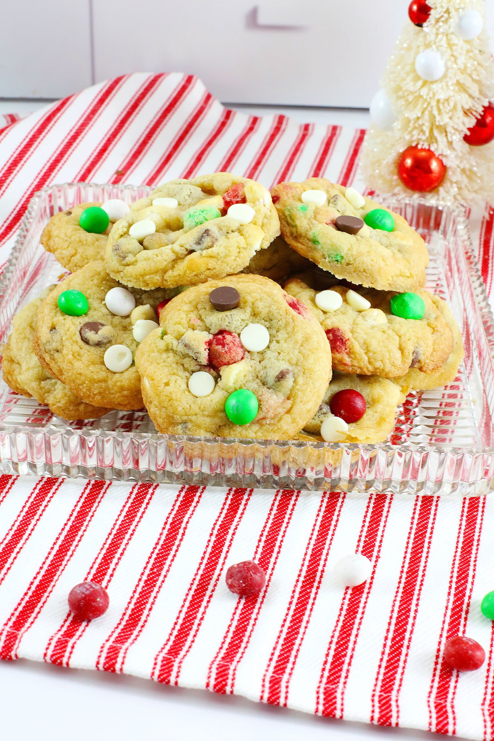 christmas toll house cookies stacked on a glass plate