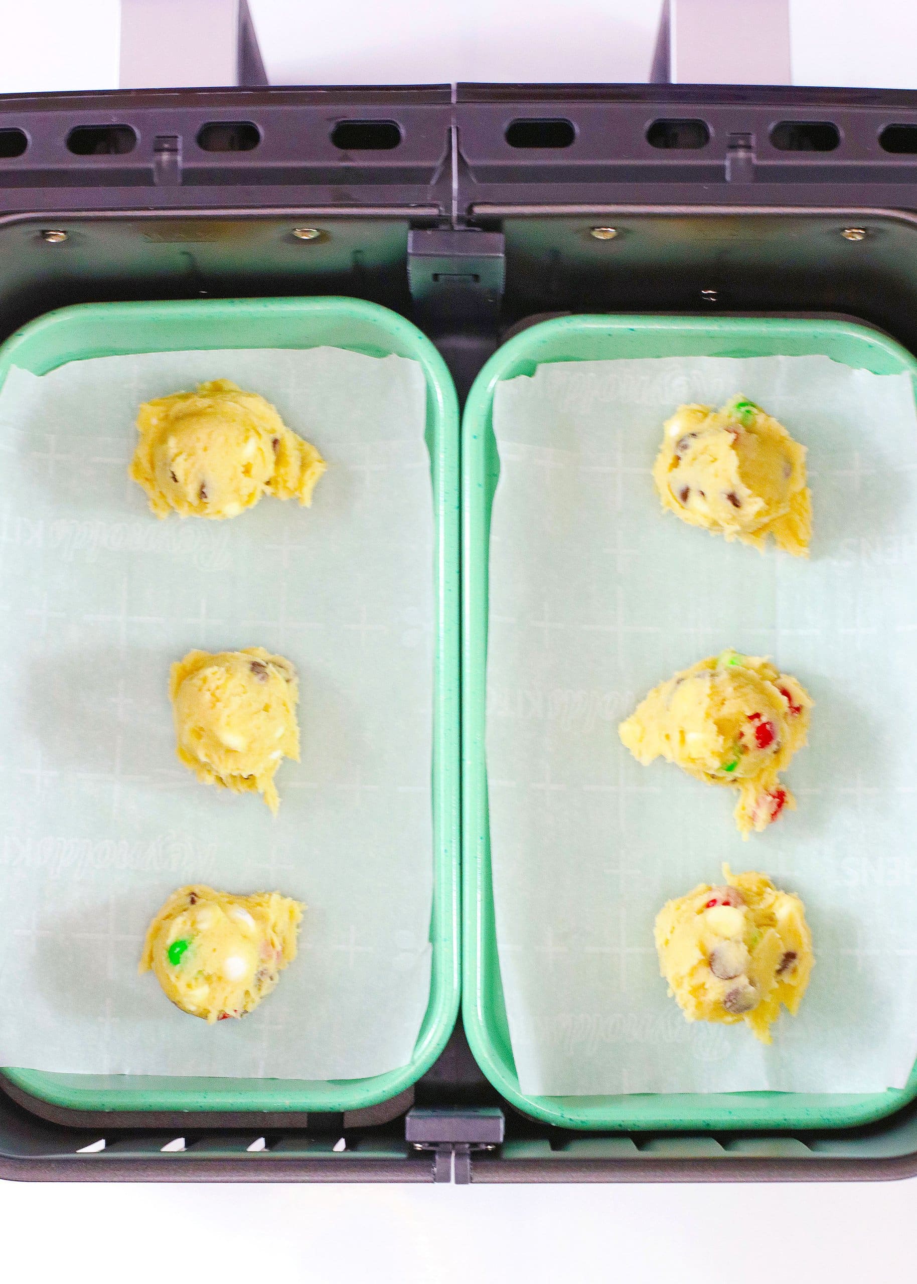 dough balls on a parchment lined baking sheet