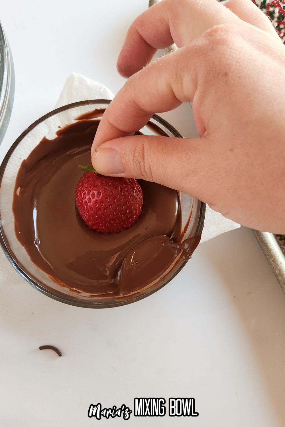 strawberry being dipped in chocolate