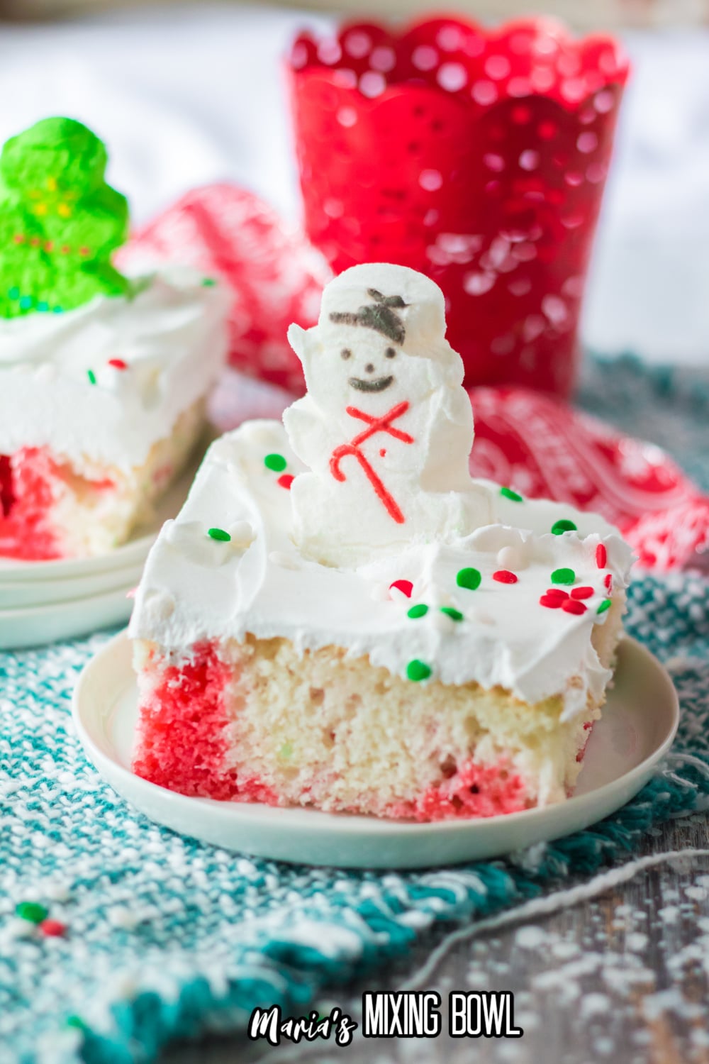 slice of christmas poke cake on small white plate