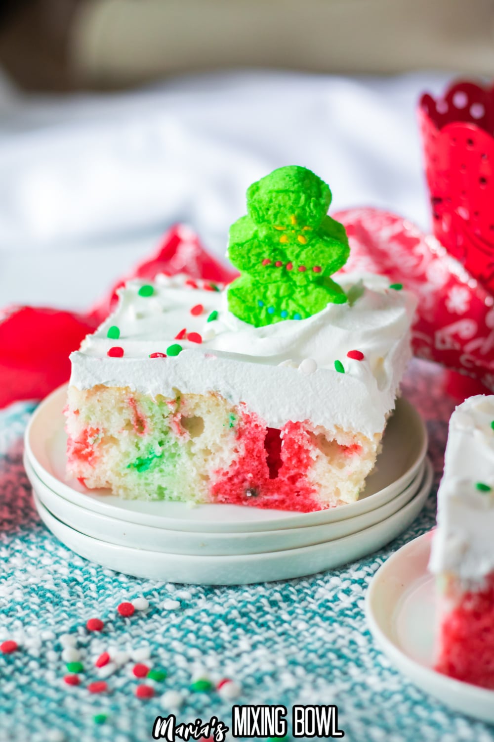 slice of christmas poke cake on small white plate
