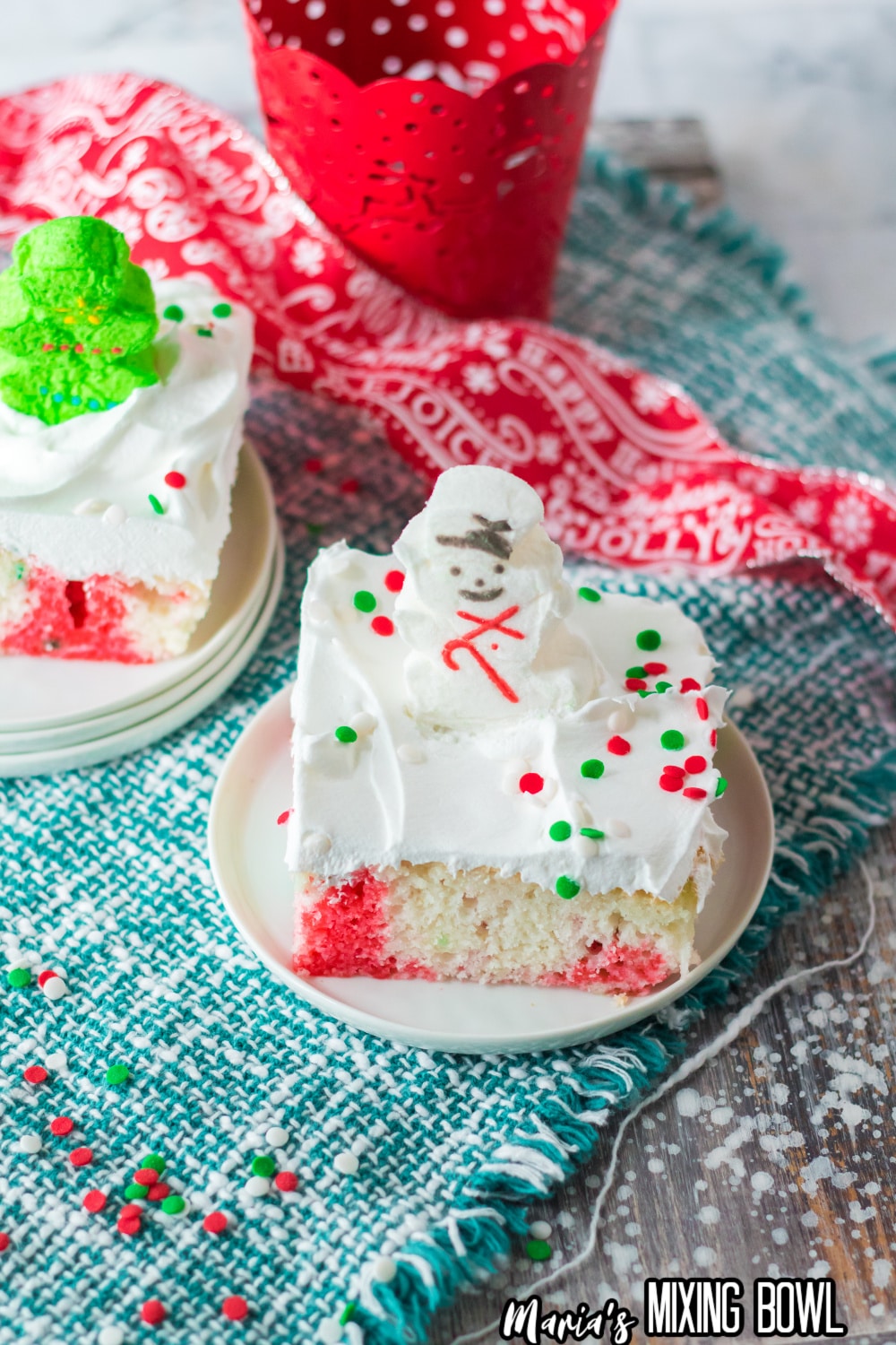 slice of christmas poke cake on small white plate