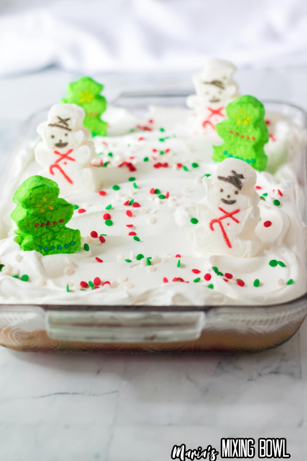 frosted cake in a glass baking pan