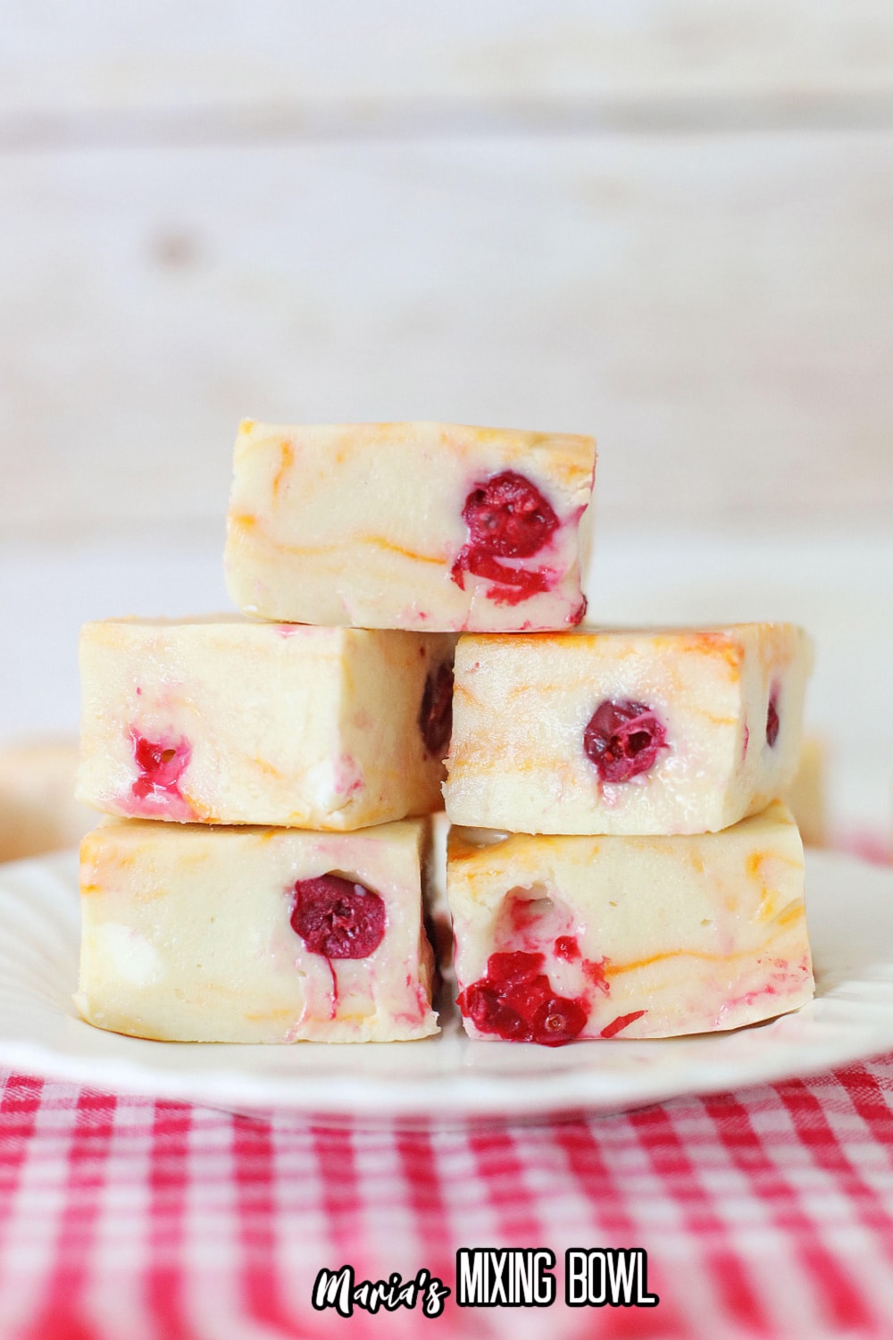 stack of cranberry orange fudge on a white plate