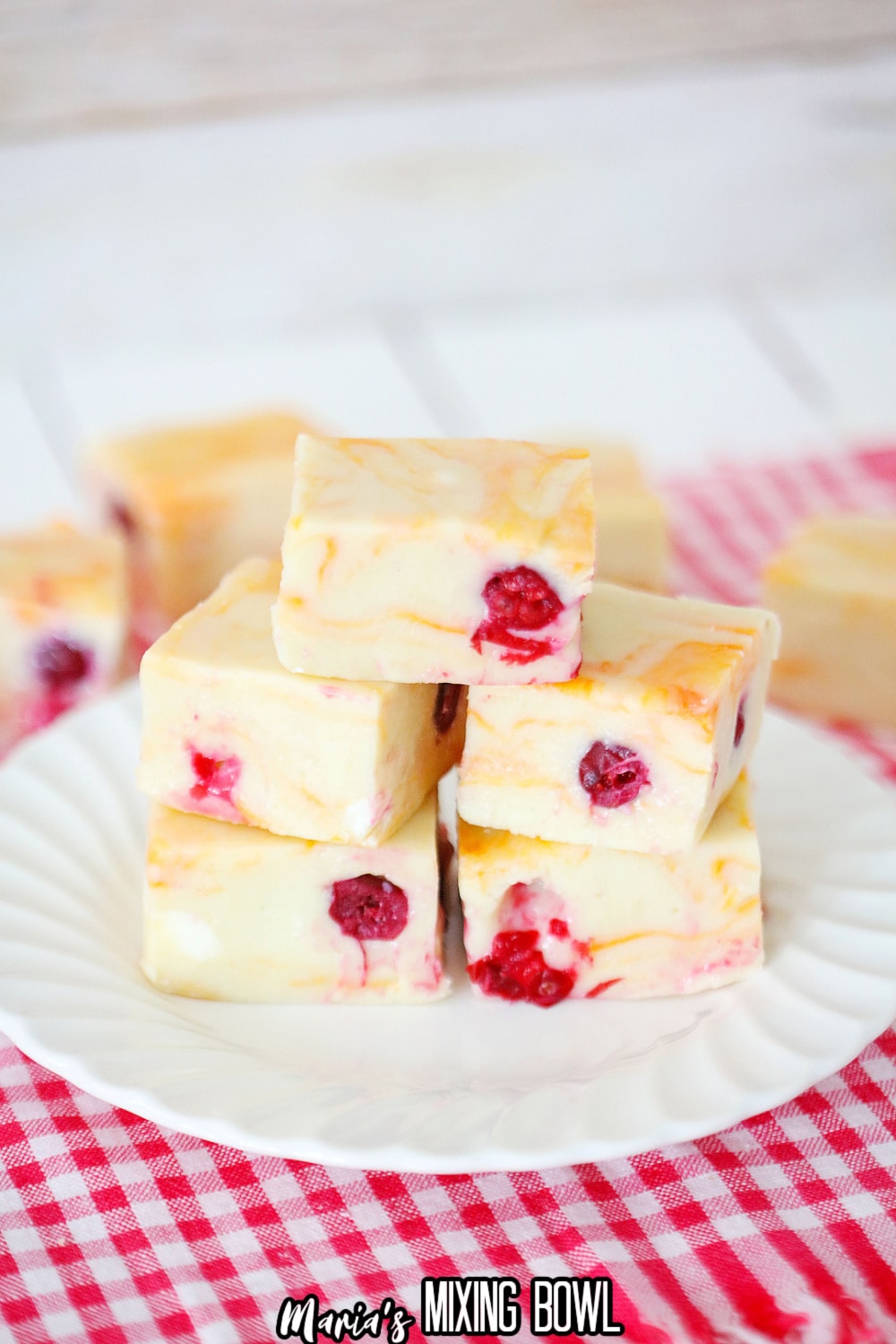 stack of cranberry orange fudge on a white plate